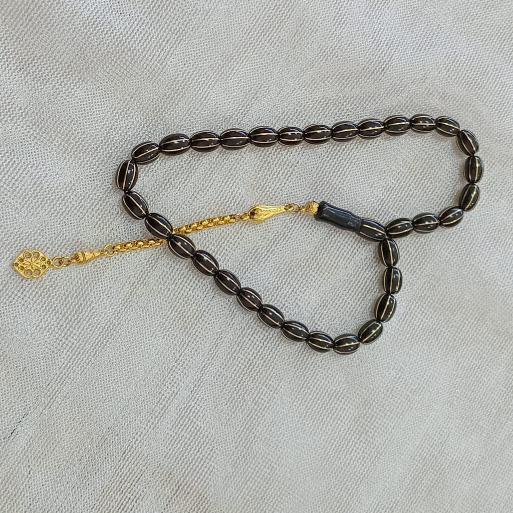 Oval-Cut Press Oltu Stone Tasbih with Brass Melon-Slice Inlay, 7.5x10.5mm